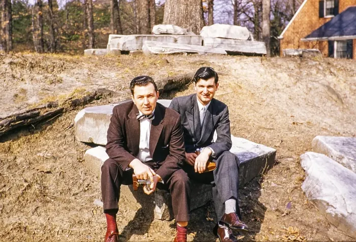 Framed Print : Two elegantly dressed men sitting outside and looking into the camera, USA around 1953