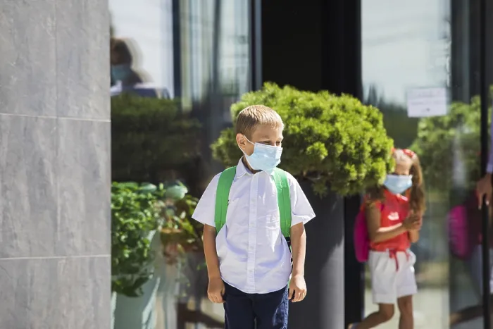 Framed Print : The elementary school student wearing a protective mask and backpack Framed Print : The elementary school student wearing a protective mask and backpack