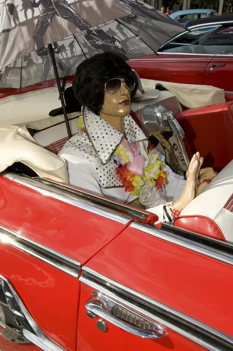 Framed Print : Elvis doll in the back seat of a red Cadillac Impala