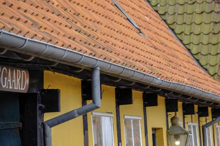 Framed Print : Engaged roofs and windows of a half-timbered house with yellow walls and tiles