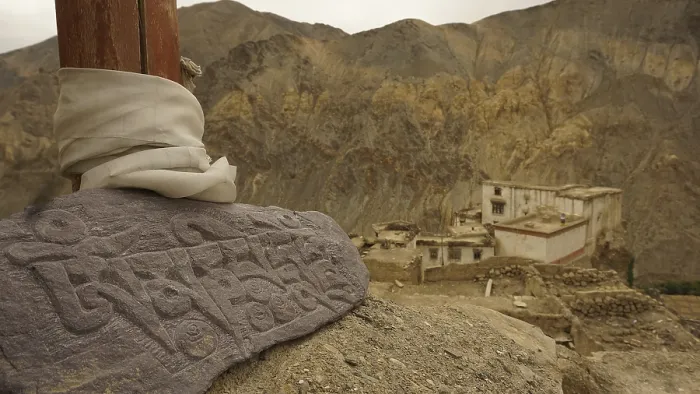 Framed Print : An engraved Mani stone in a mountainous landscape
