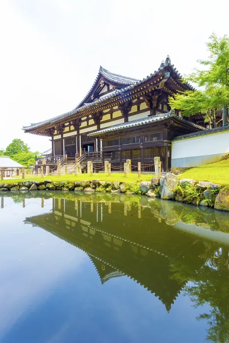 Framed Print : Front entrance of Sangatsu-do Hall reflected in the front pond on a sunny morning in the Todai-ji temple complex