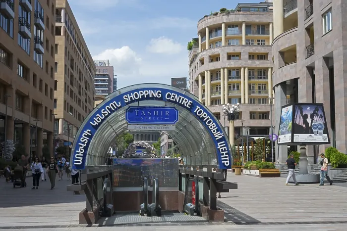 Framed Print : Entrance to a shopping centre with a modern architectural style in a lively environment