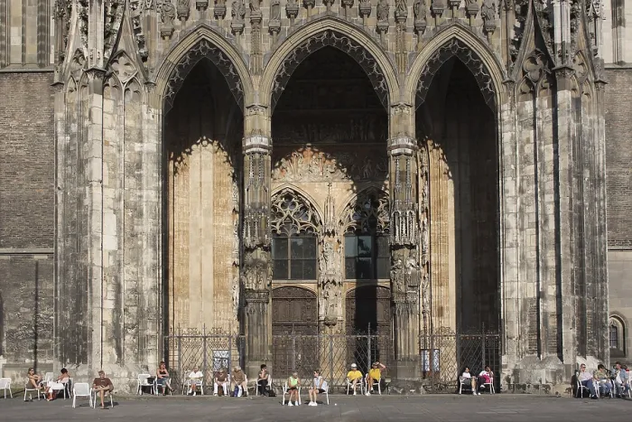 Framed Print : Entrance to Ulm Cathedral with people standing in front on Muensterplatz Framed Print : Entrance to Ulm Cathedral with people standing in front on Muensterplatz