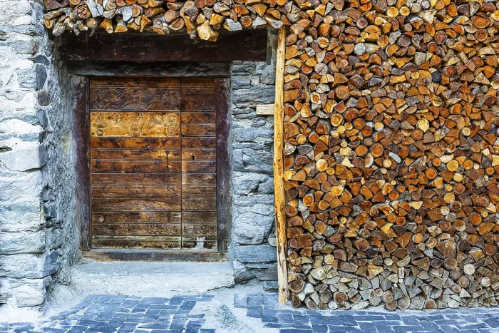 Framed Print : Entrance to a wine cellar framed by firewood logs