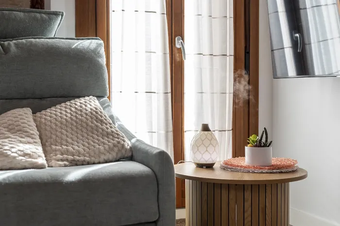 Framed Print : Essential oil diffuser releasing aromatic mist on a side table creating a relaxing atmosphere in a modern home