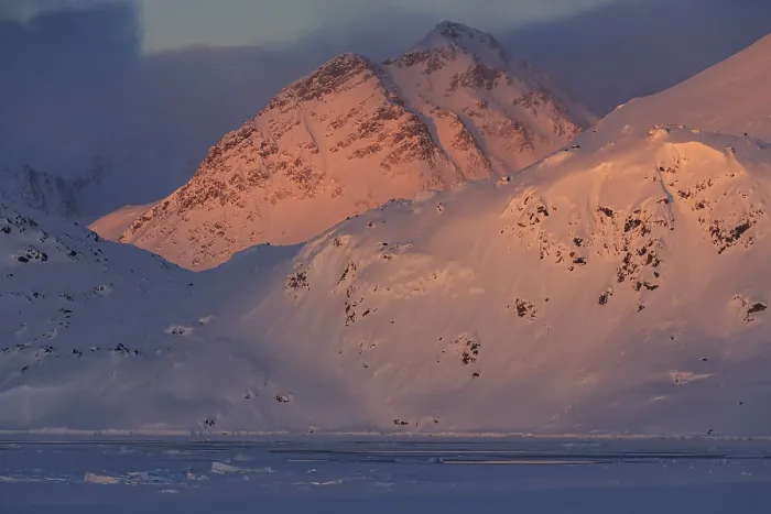 Framed Print : Evening light on snowy mountains