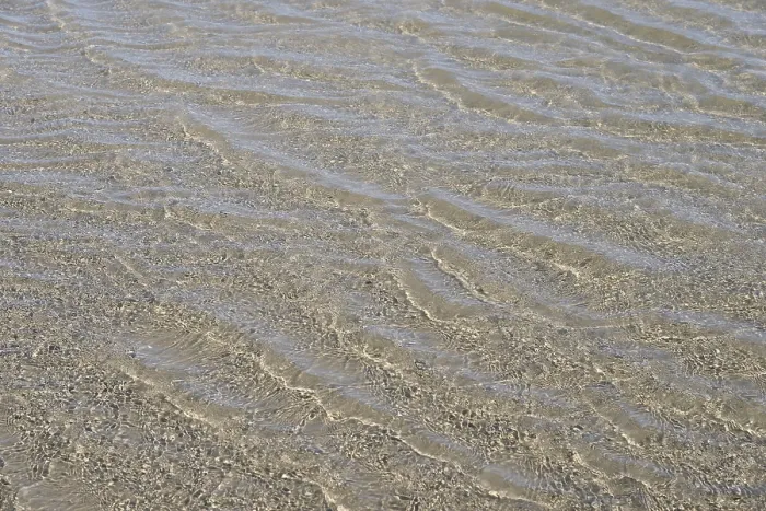 Framed Print : Evenly flowing waves on a sandy beach