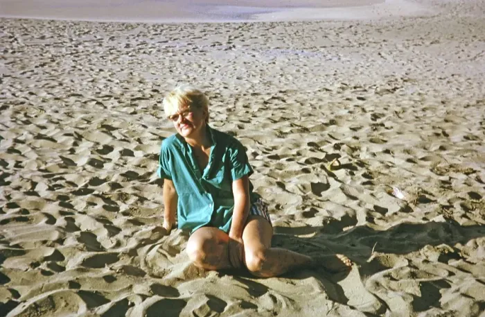 Framed Print : Expatriate tourist woman sitting on sandy beach, island of Tobago, 1963
