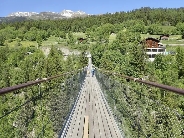 Framed Print : Extensive suspension bridge in idyllic mountain and forest areas in sunny weather