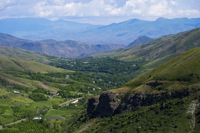 Framed Print : Extensive valley surrounded by green mountains