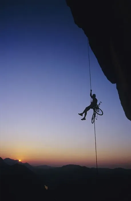 Framed Print : Extreme sport, a man abseiling with a bike in front of the sunset