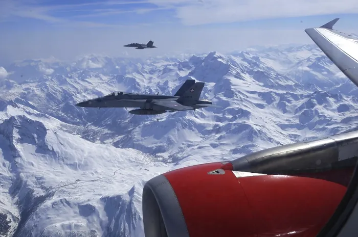 Framed Print : Two FA-18 Fighters Accompaning a Civil Airplaine over the Swiss Alps