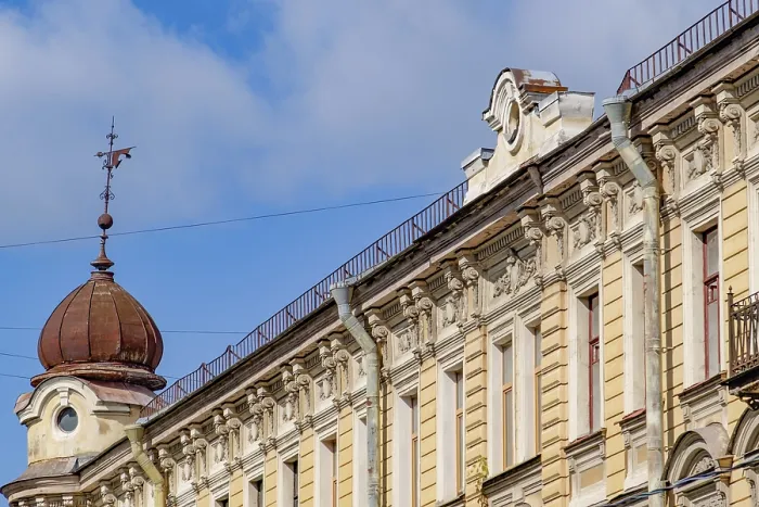Framed Print : Facade of a historic building with decorated reliefs and dome under a blue sky