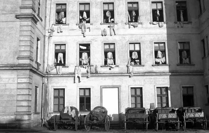 Framed Print : Facade of houses, on which clothes were hung for drying on window crosses Framed Print : Facade of houses, on which clothes were hung for drying on window crosses