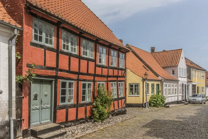 Framed Print : The facade of a red two stock half-timbered house in a cobbled street Framed Print : The facade of a red two stock half-timbered house in a cobbled street