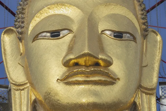 Framed Print : Face of a 32 metre high standing Buddha decorated with glass mosaics and 24-carat gold Framed Print : Face of a 32 metre high standing Buddha decorated with glass mosaics and 24-carat gold