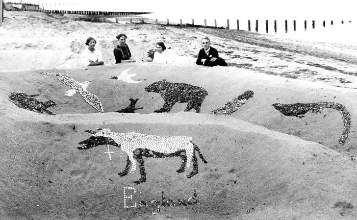 Framed Print : Family on a sandy beach with sandcastle