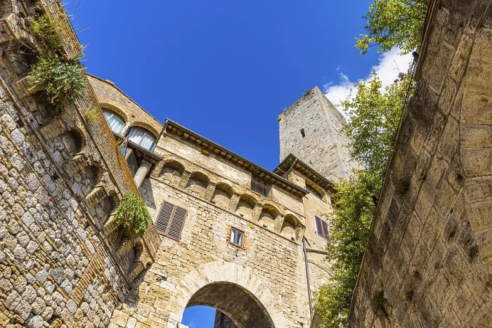 Framed Print : Family tower and medieval buildings against a blue sky