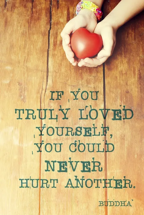 Framed Print : Famous Buddha quote about hurt another printed over image with red heart in hands