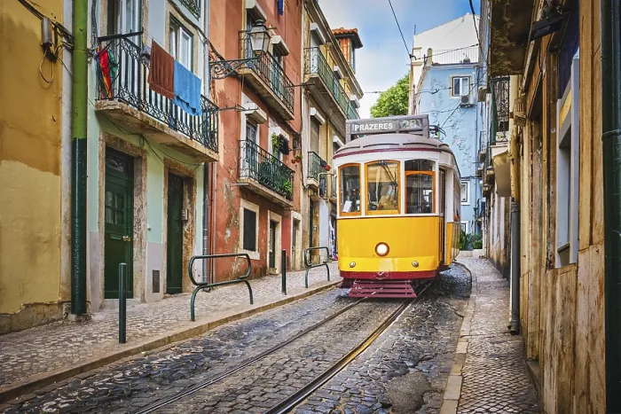 Framed Print : Famous vintage yellow tram 28 in the narrow streets of Alfama district in Lisbon