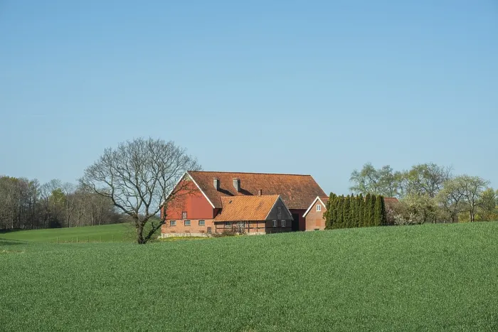 Framed Print : Farm at green field and blue sky in springtime in Ystad Municipality