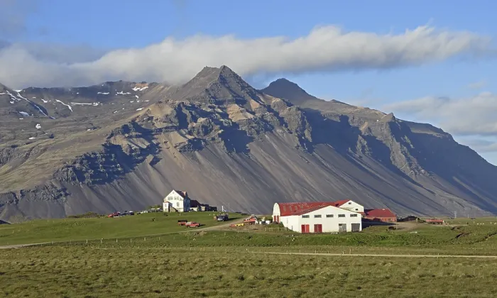 Framed Print : Farm and mountain scenery with eroded scree slope in the evening light near Hofn