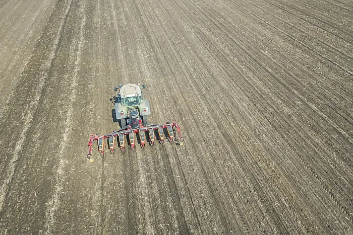 Framed Print : Farmer seeding crops at field. Seeding Aerial View