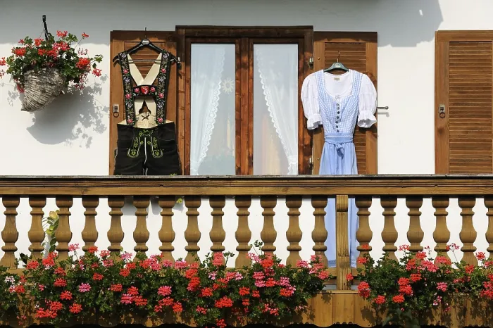 Framed Print : Farmhouse with lederhosen and a dirndl hanging on the shutters Framed Print : Farmhouse with lederhosen and a dirndl hanging on the shutters