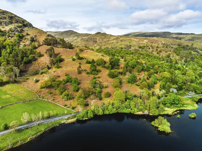 Framed Print : Farms and Mountains over road A591 from a drone