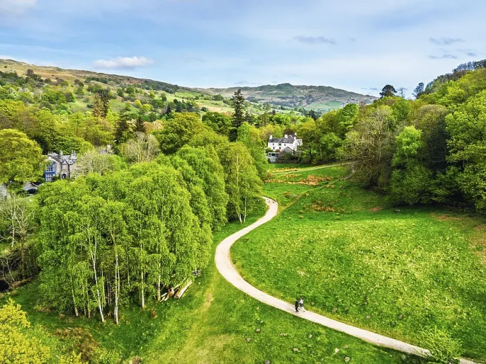 Framed Print : Farms and Mountains over road A591 from a drone