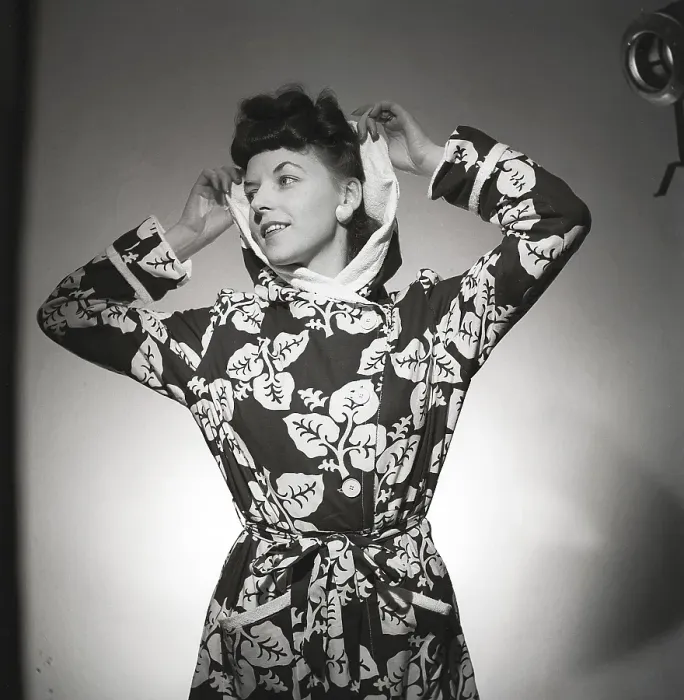 Framed Print : Fashion in the 1940s. A young woman in a photographers studio is wearing a patterned bathrobe Framed Print : Fashion in the 1940s. A young woman in a photographers studio is wearing a patterned bathrobe