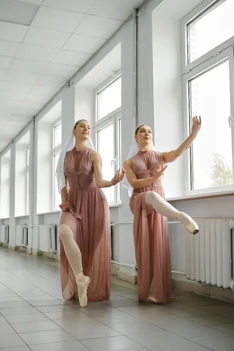 Framed Print : Female ballerinas use a free minute to repeat exercises