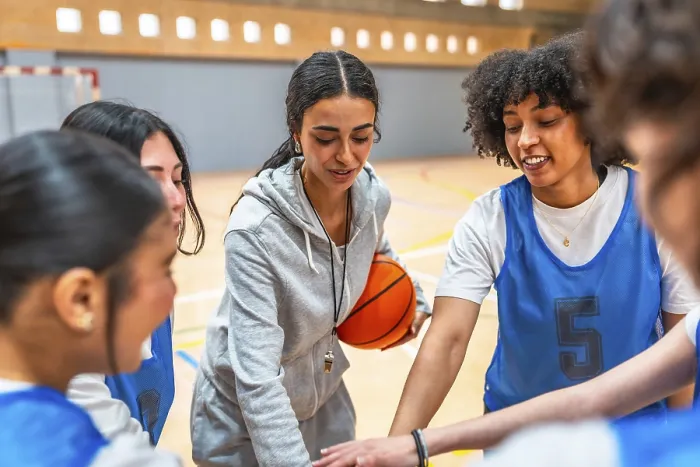 Framed Print : Female basketball coach motivating and inspiring her team during a time out Framed Print : Female basketball coach motivating and inspiring her team during a time out