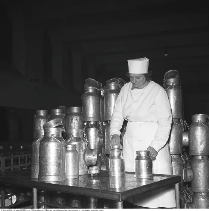 Framed Print : Female dairymaid with various containers for storing dairy products