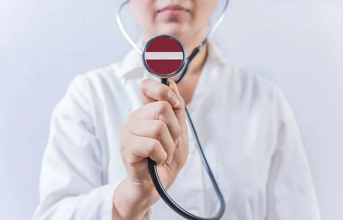 Framed Print : Female Doctor Holding Stethoscope With Latvia Flag