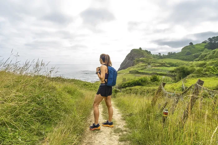 Framed Print : Female hiker enjoying the scenic view of sakoneta beach and its flysch cliffs in zumaia