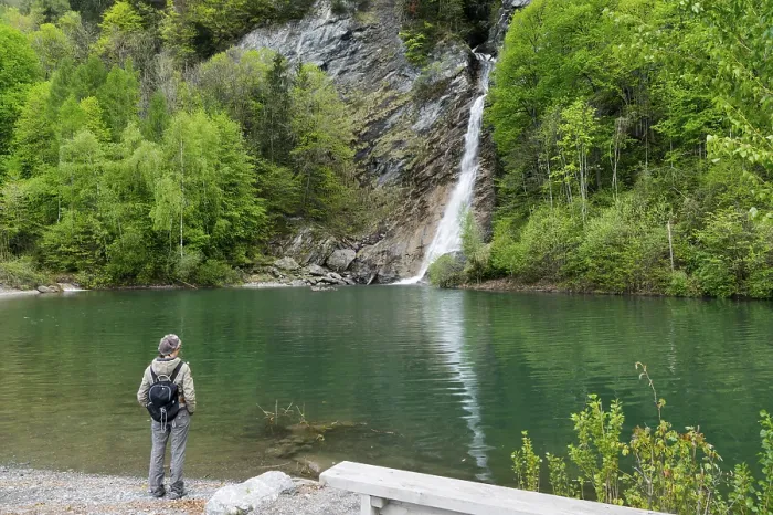 Framed Print : female hiker looking at the Saarbach waterfall