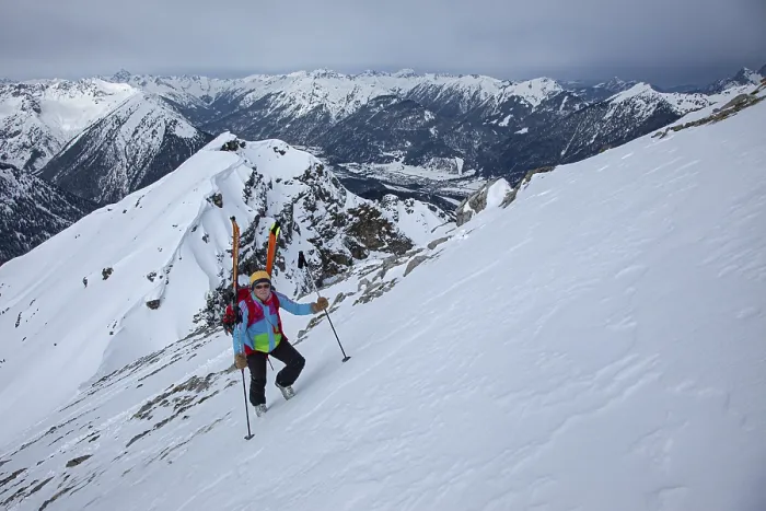 Framed Print : A female ski tourer with skis on her rucksack in steep terrain Framed Print : A female ski tourer with skis on her rucksack in steep terrain