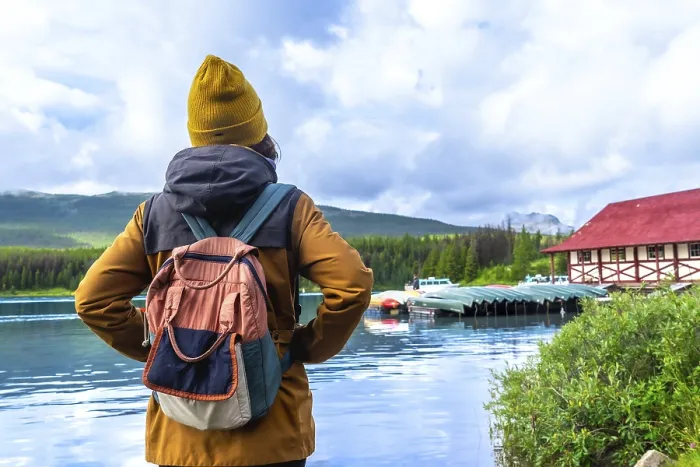 Framed Print : Female tourist with a backpack admiring the stunning view of maligne lake Framed Print : Female tourist with a backpack admiring the stunning view of maligne lake