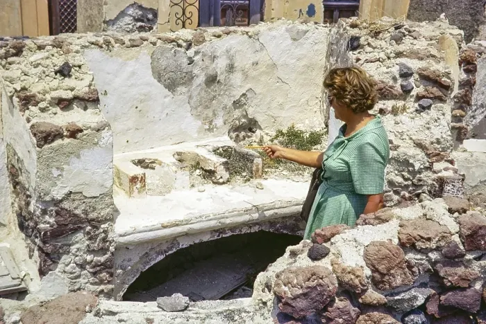 Framed Print : Female woman tourist looking at ruins of old domestic kitchen, Oia, Santorini, Cyclades islands, Greece, Europe, 1972, Europe