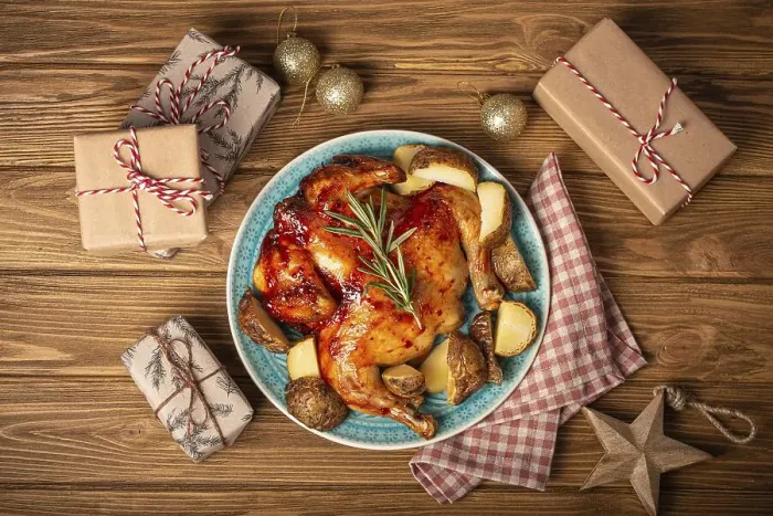 Framed Print : Festive Christmas dinner with roasted whole chicken top view on wooden rustic background with Xmas toys