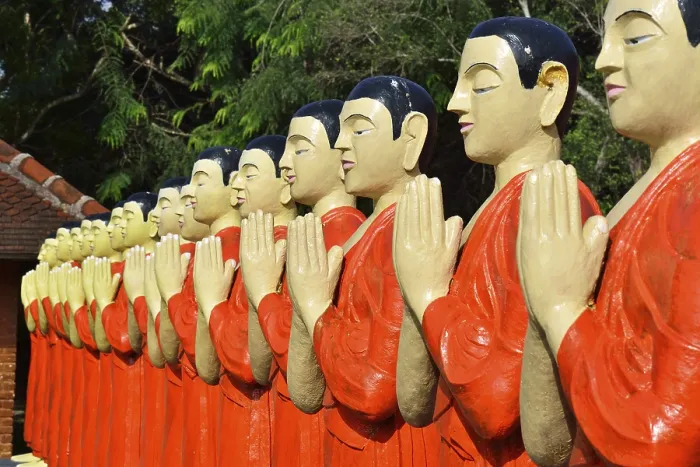 Framed Print : Figures of Buddhist monks in front of a monastery