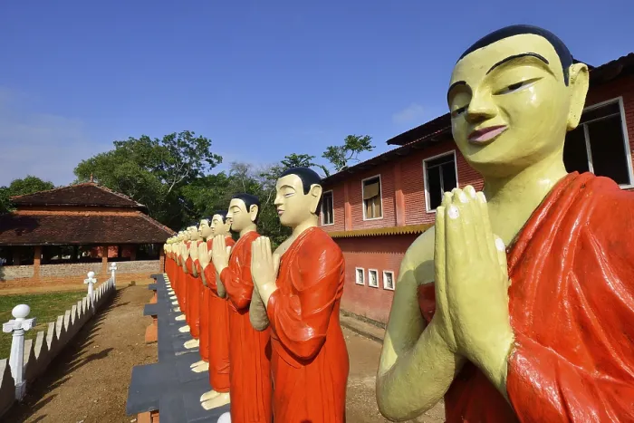 Framed Print : Figures of Buddhist monks in front of a monastery
