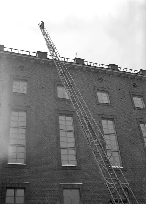 Framed Print : Fire in the 1940s. Firefighter from Kungsholmen's fire station walks up the ladder that is set up against a house Framed Print : Fire in the 1940s. Firefighter from Kungsholmen's fire station walks up the ladder that is set up against a house