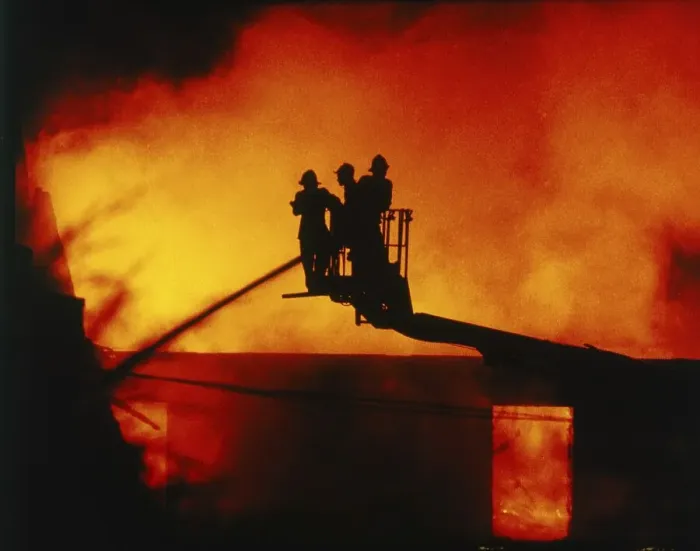 Framed Print : Firefighters extinguish a fire