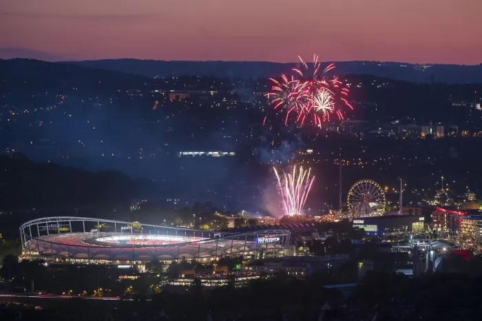Framed Print : Fireworks at night illuminate the city above a stadium