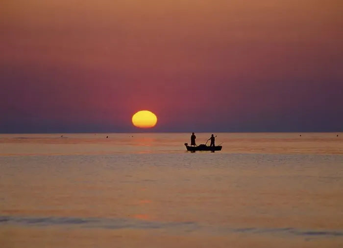 Framed Print : Fishing boat on the sea in the sunset