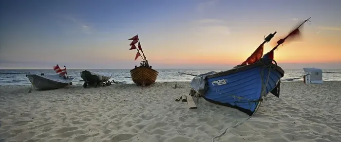 Framed Print : Fishing boats on beach at sunrise