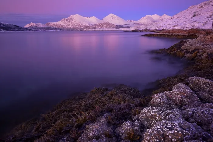 Framed Print : Fjord with stones in front of a mountain range in the evening light Framed Print : Fjord with stones in front of a mountain range in the evening light